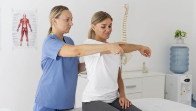 physiotherapist-helping-female-patient-her-clinic-min